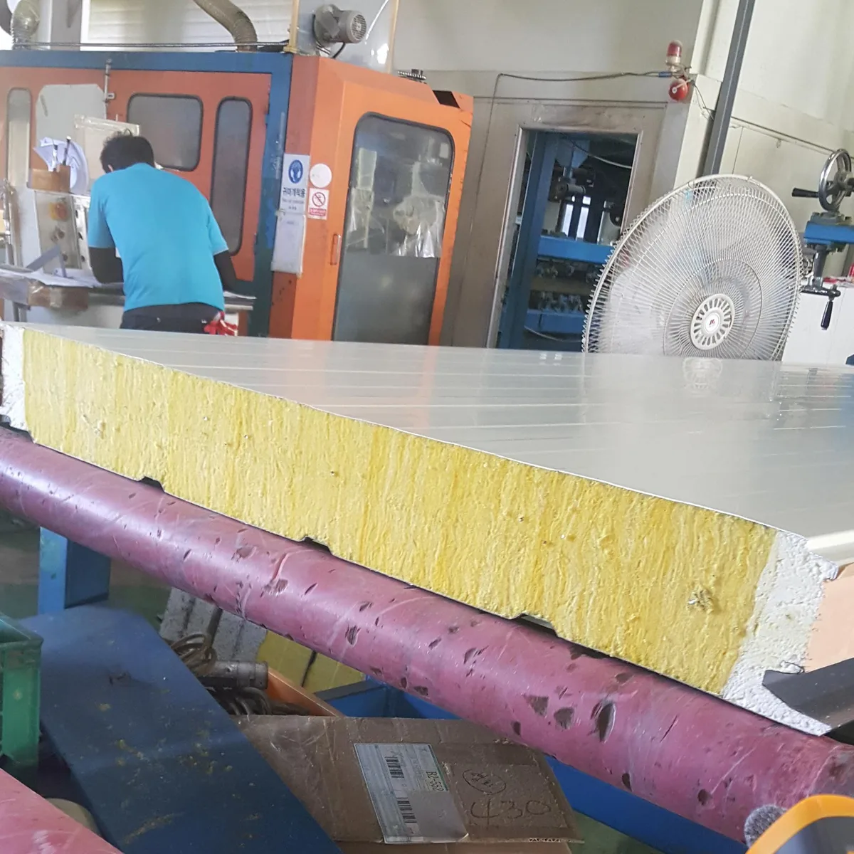 Glass wool panel adhesive bonding process at manufacturing line